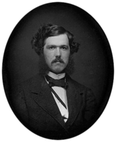 Photographie en noir et blanc d'un jeune homme avec une moustache