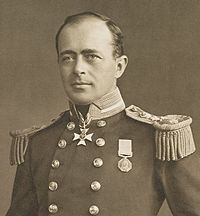 Homme avec dégarni, regardant à gauche, portant l'uniforme de la marine avec des médailles, boutons polis et grandes épaulettes