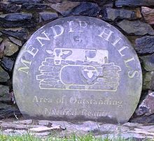 Degradado placa circular azul con el logotipo de las colinas de la zona de excepcional belleza natural Mendip