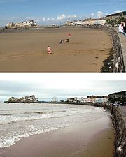 Dos fotografías de la pared del mar y de los edificios. La izquierda tuvo lado es una extensión de arena en la imagen superior y agua cubierta en la imagen inferior.