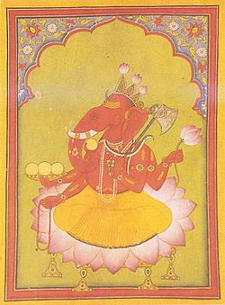 Vestido con un dhoti naranja, un hombre con cabeza de elefante se sienta en una gran flor de loto. Su cuerpo es de color rojo y lleva varios collares y pulseras de oro y una serpiente alrededor de su cuello. En los tres puntos de su corona, flores de loto en ciernes han sido corregidos. Él tiene en sus dos manos derechas del rosario (menor mano) y una copa llena con tres modakas (redondos dulces amarillos), cuarto modaka en poder del tronco curva es a punto de ser probado. En sus dos manos izquierdas, que sostiene un loto por encima y por debajo de un hacha, con su mango apoyado en su hombro.